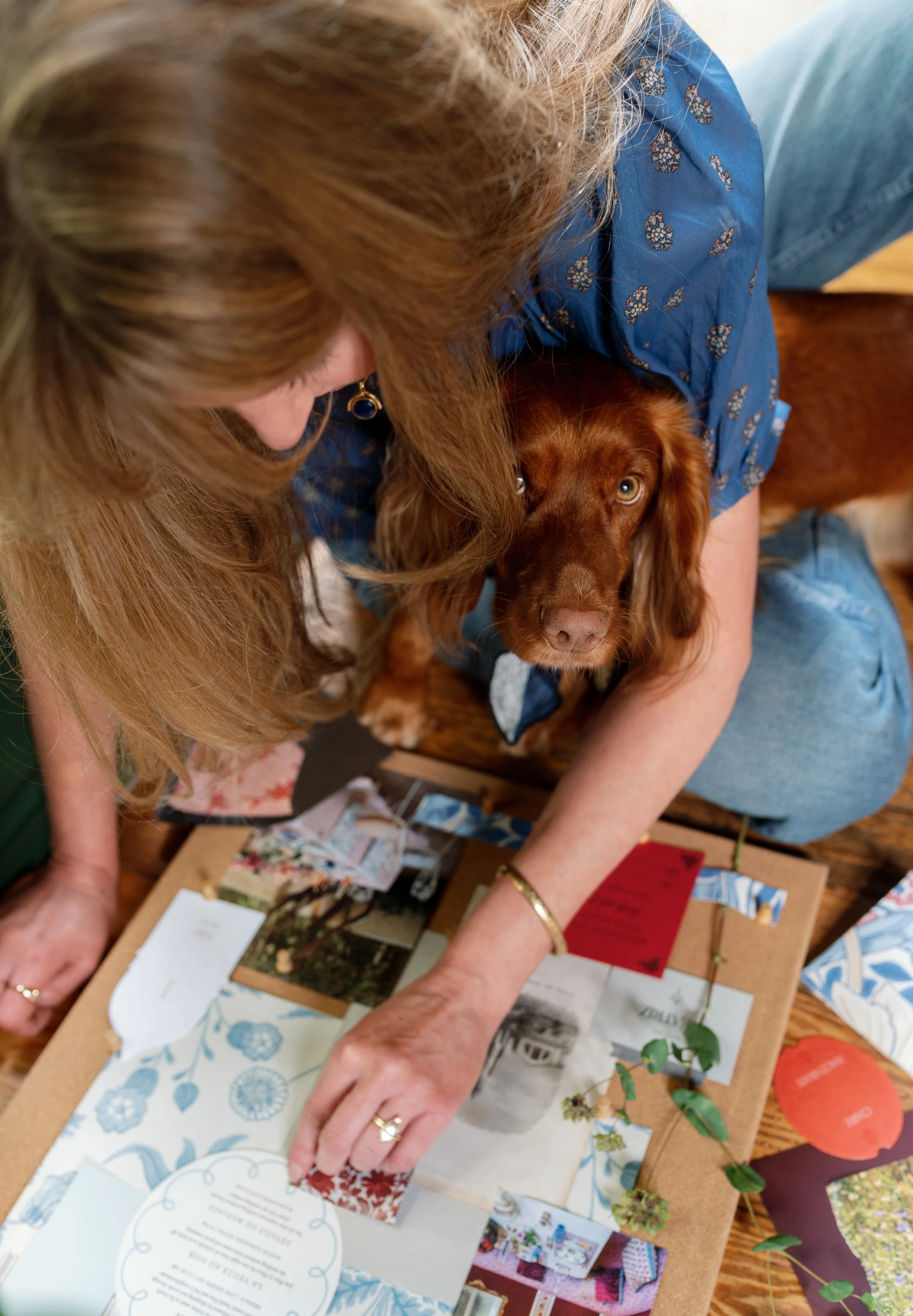 Merci Studio founder Meredith Cochran reviewing photographs, paper goods, and creative references.