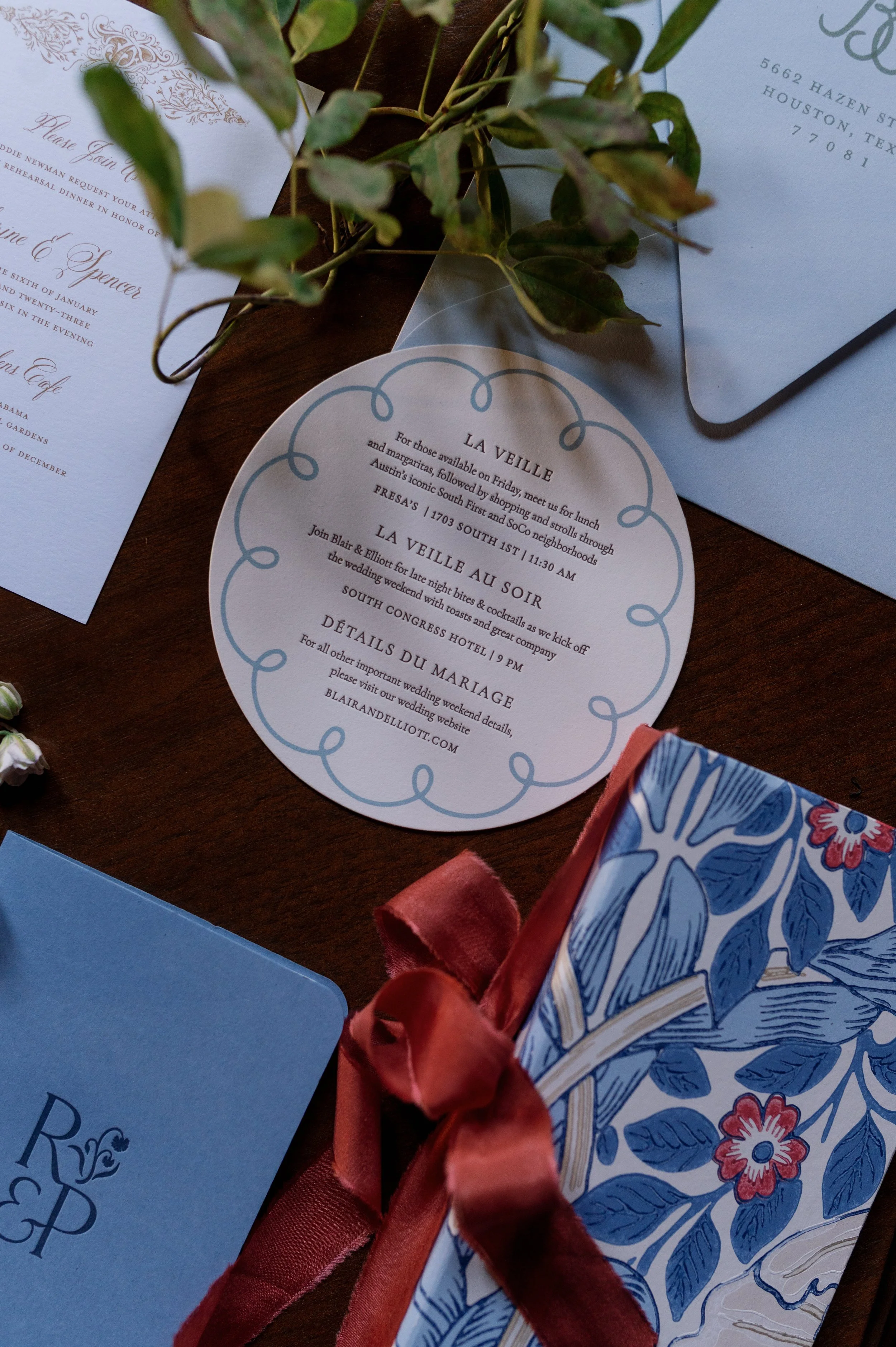Bespoke wedding invitation suite with custom shapes, ribbon, and botanical details by Merci Studio.