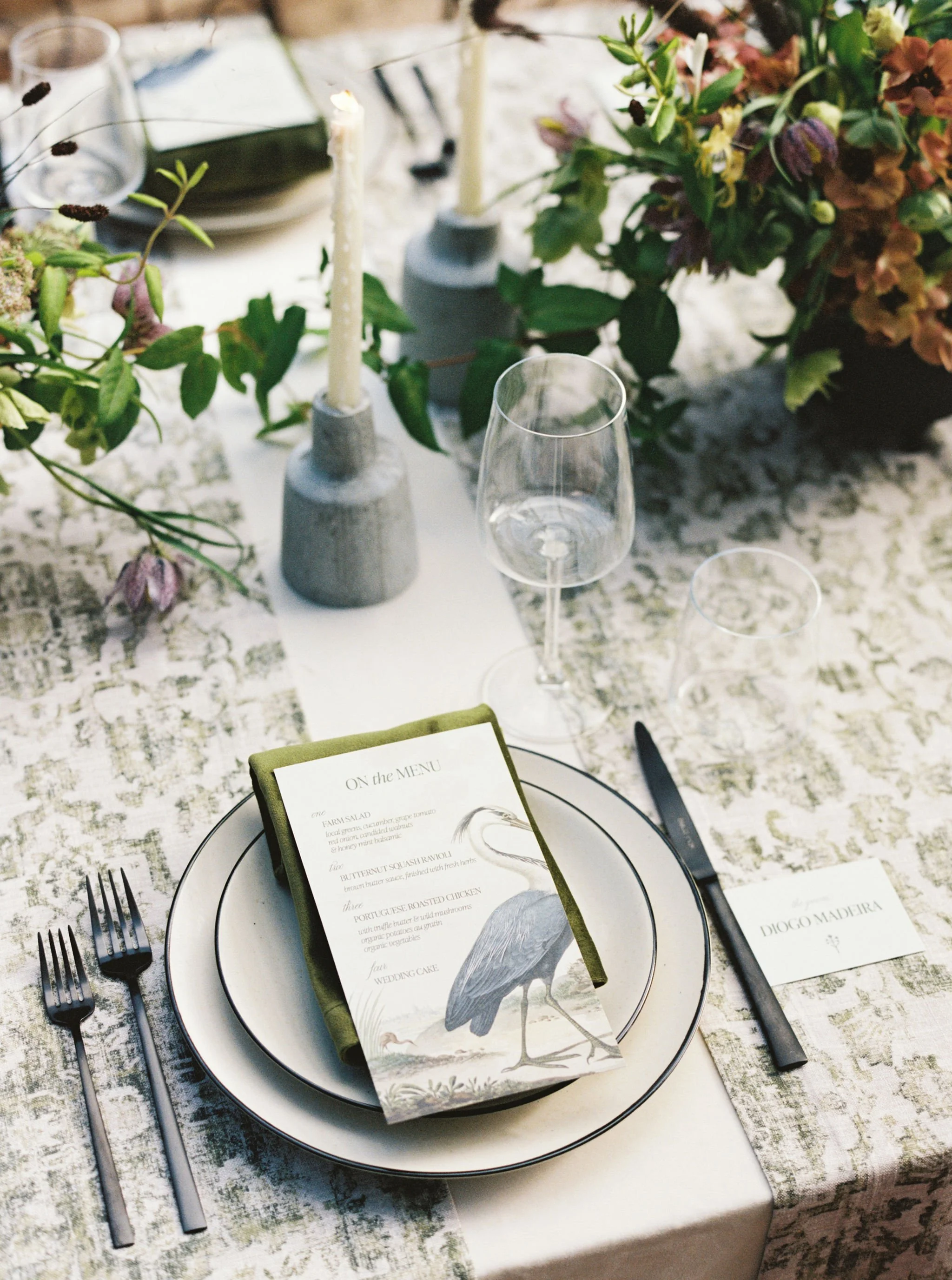 Custom illustrated wedding menu featuring a hand-drawn heron by Merci Studio.