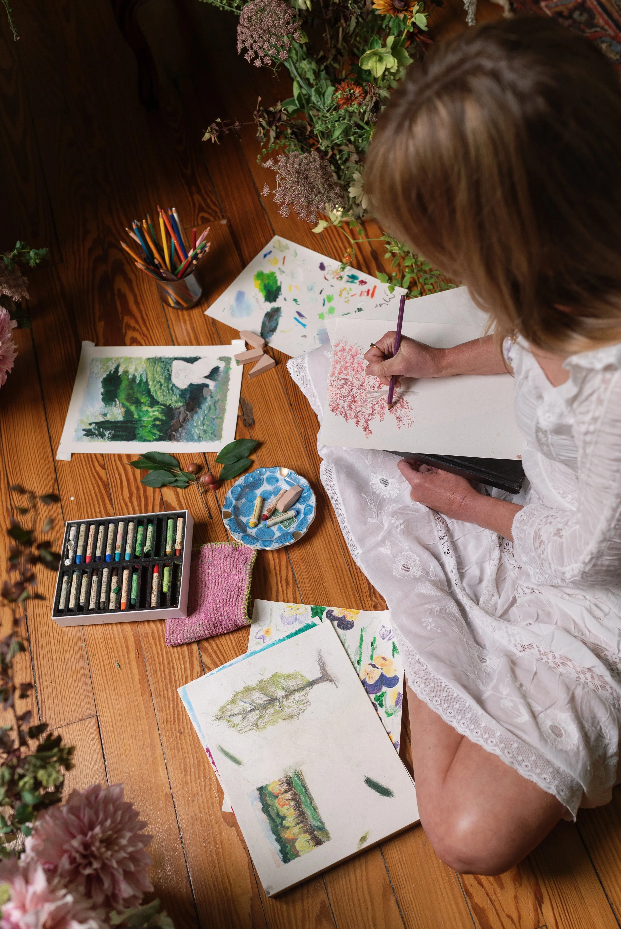 Merci Studio founder and artist Meredith Cochran creating hand-painted watercolor artwork for custom stationery.