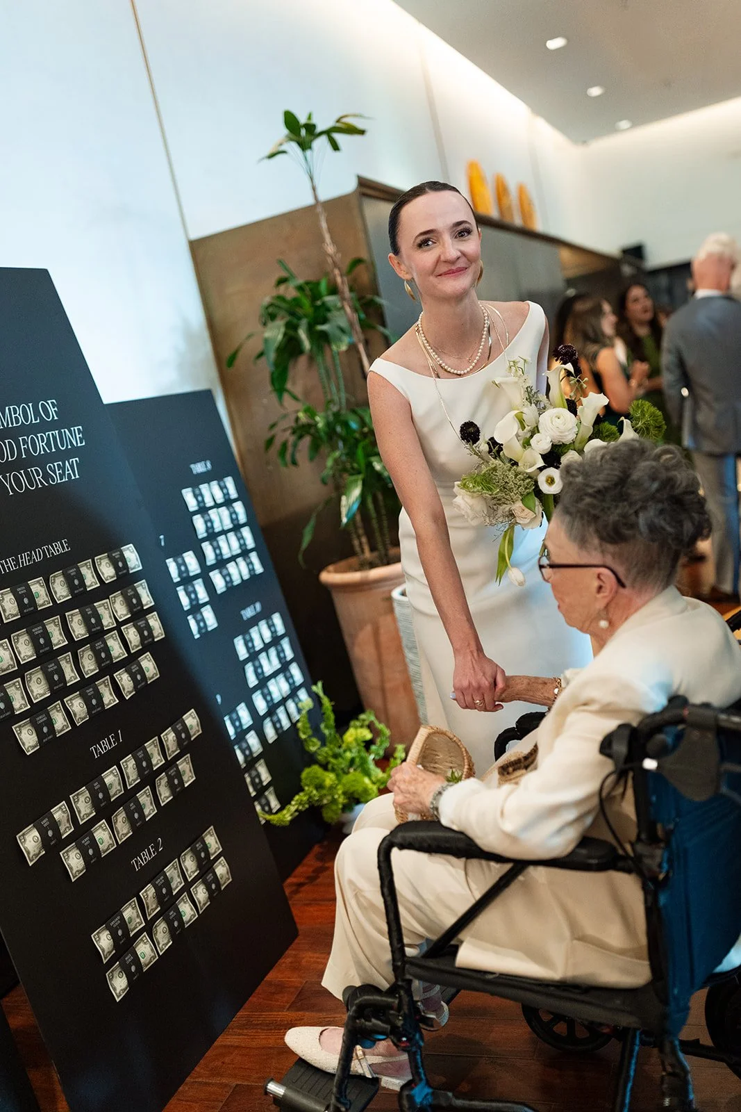 Bride with a custom seating chart created for Kristen and Cameron’s Austin wedding.