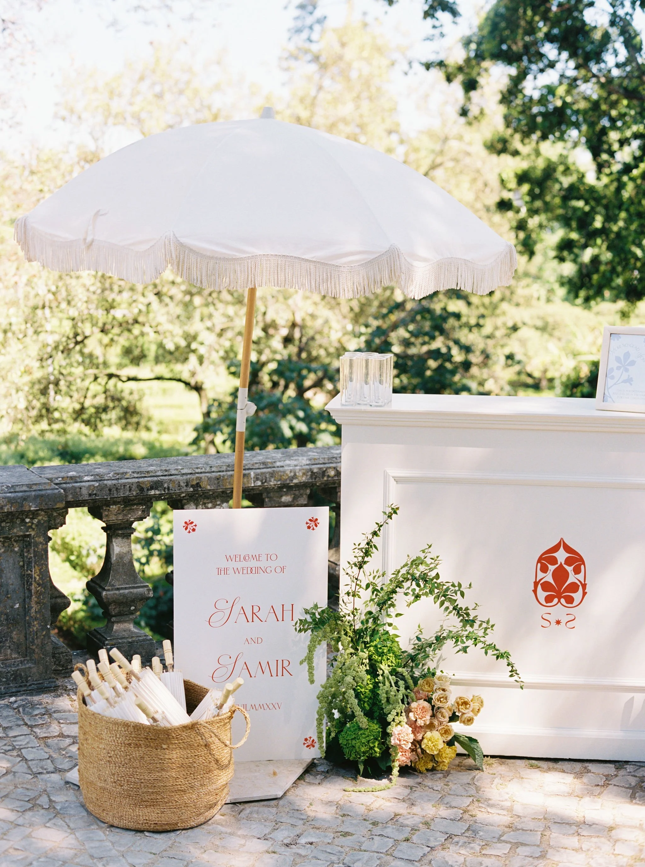 Outdoor wedding setting with custom signage, florals, and guest details created for the celebration.