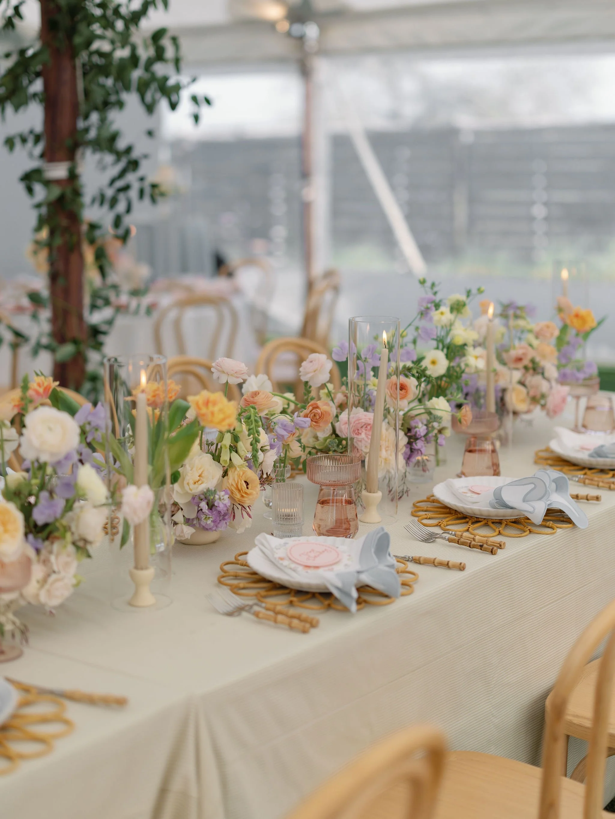Brianna and Bryce’s Texas Hill Country wedding reception with custom stationery, colorful florals, and candles.