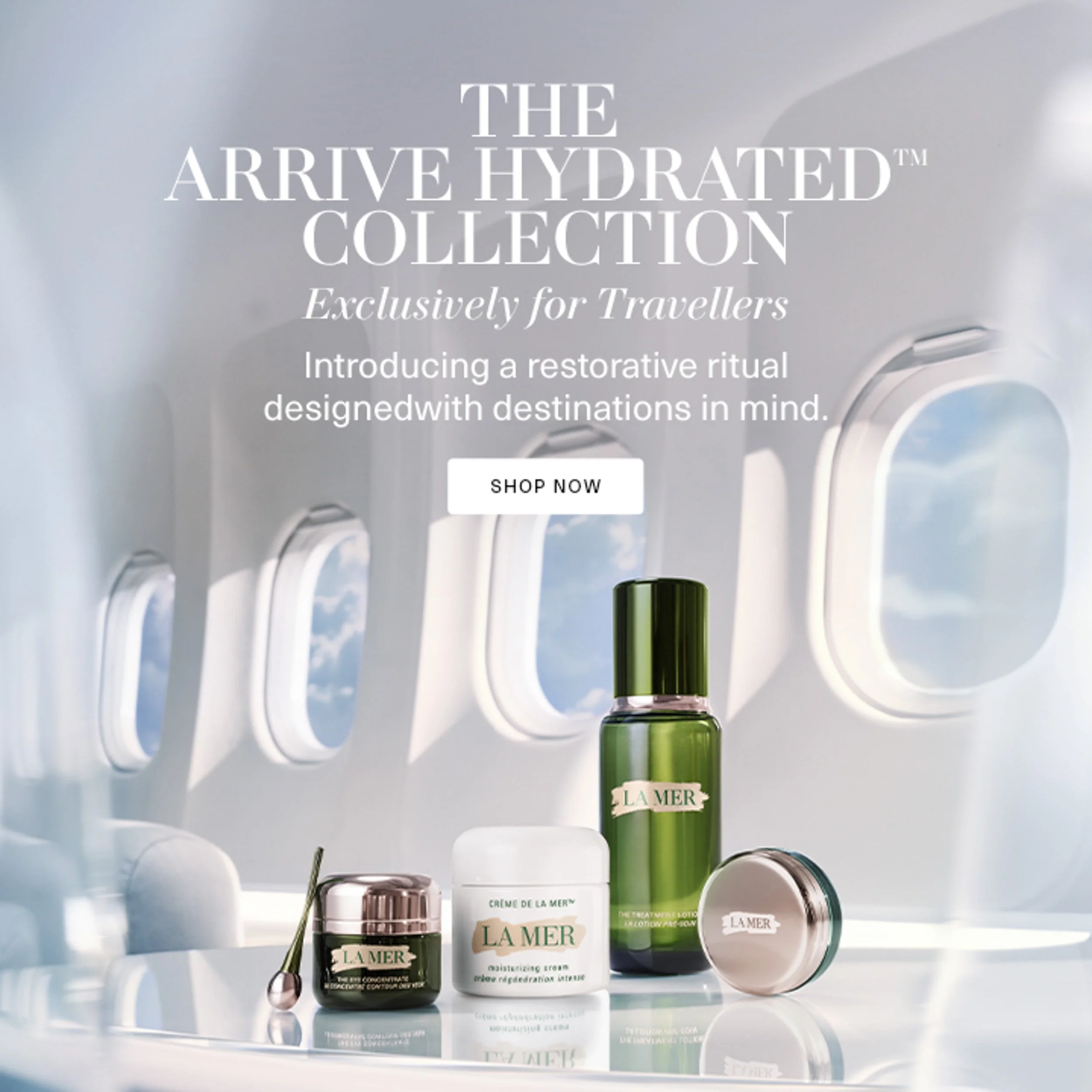 Skincare product display of La Mer jars and bottles arranged against an airplane cabin window background, with "Arrive Hydrated" text overlay.