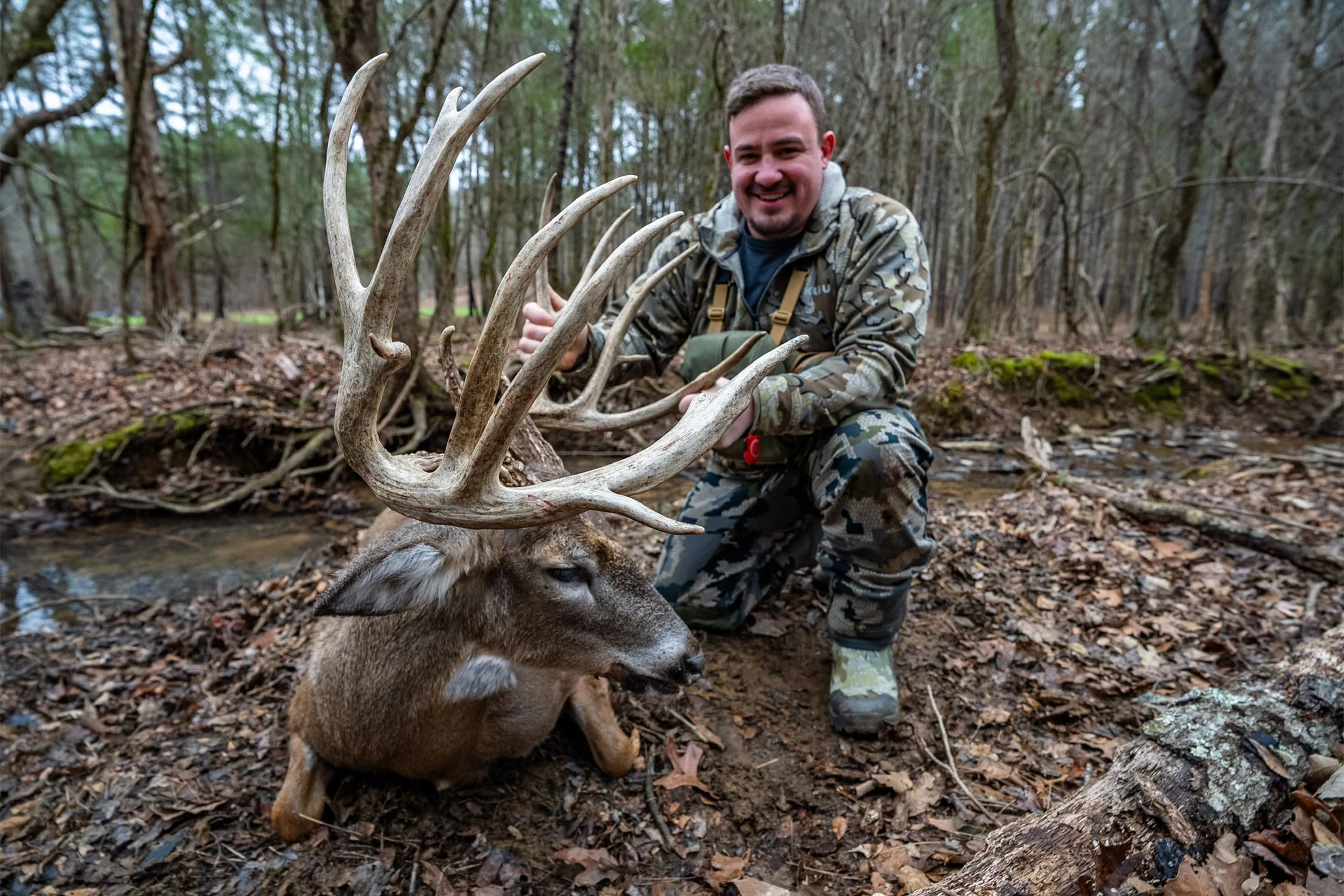 Hunter with trophy whitetail deer during a Stouts Mountain Ranch hunt