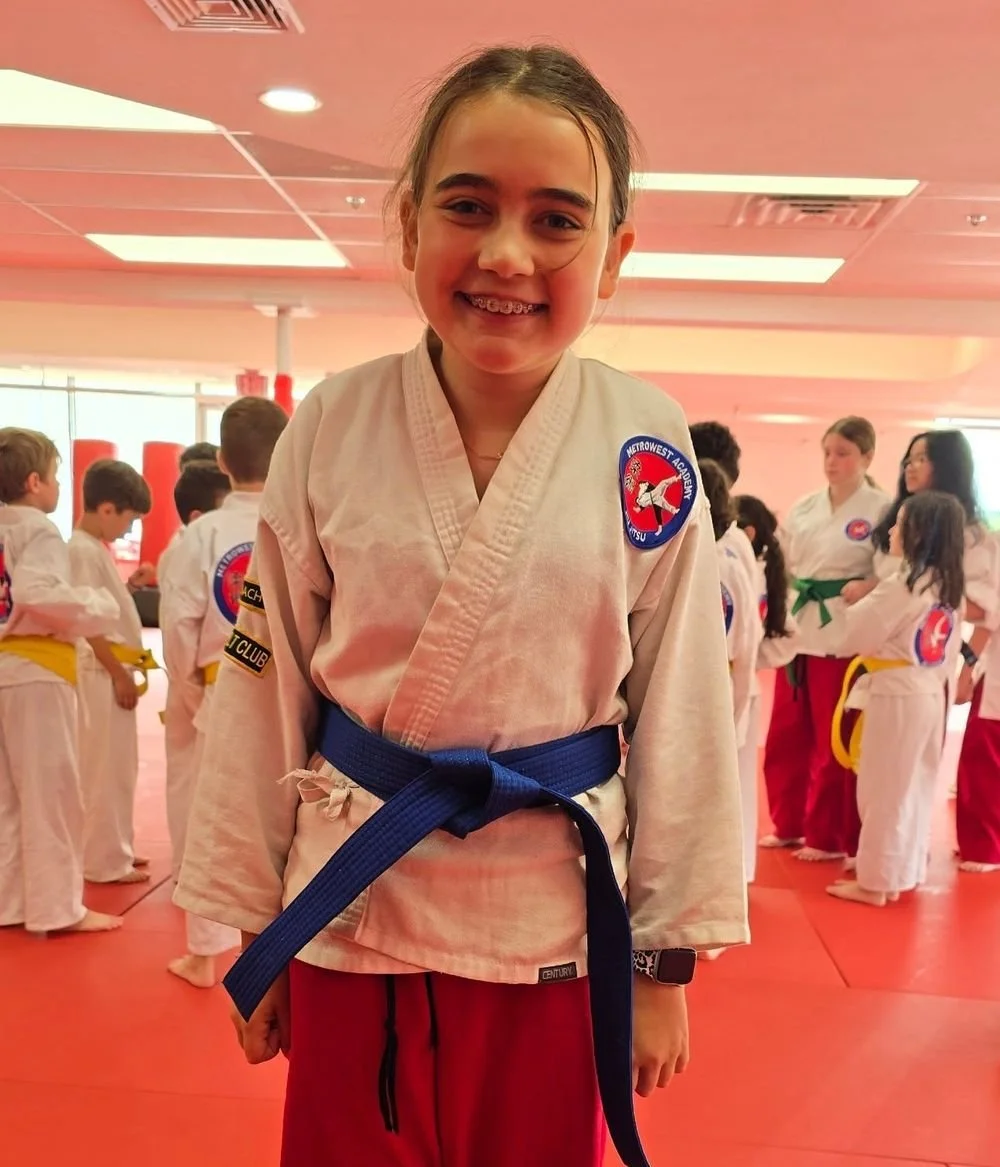 A Kids student smiling on the mat at Metrowest Academy