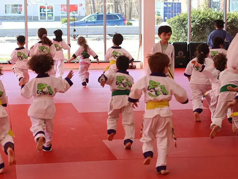 Preschoolers practicing a balance drill in the Little Ninjas class