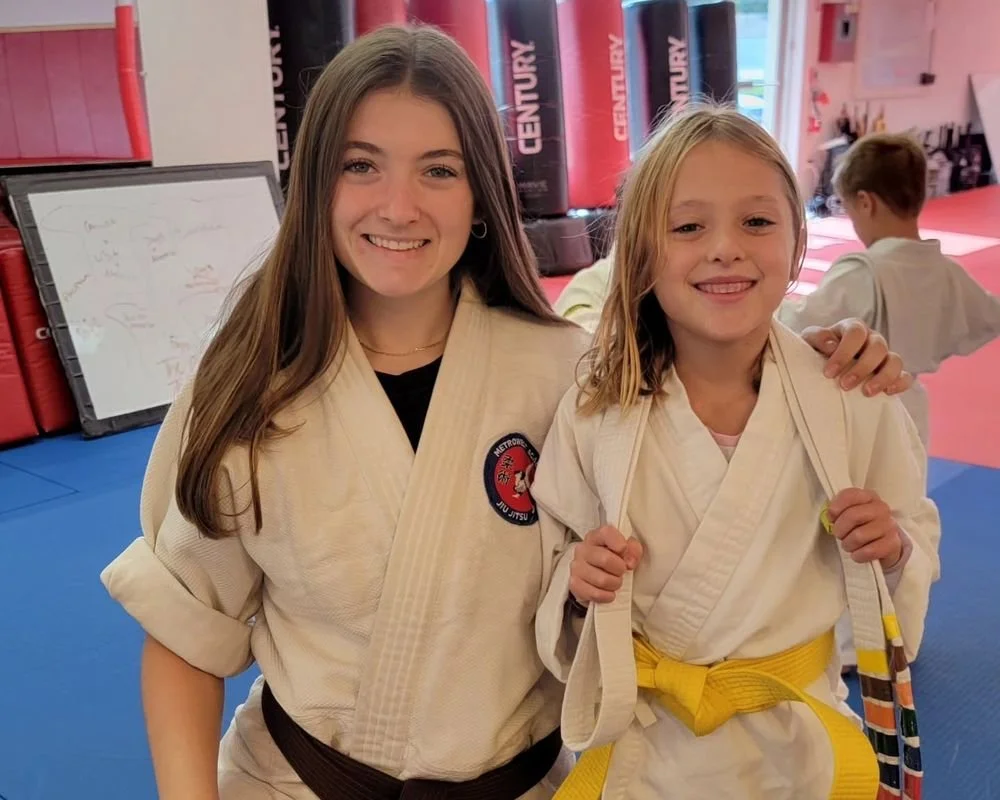 A Mentor-level Leadership Team student alongside a younger student at Metrowest Academy