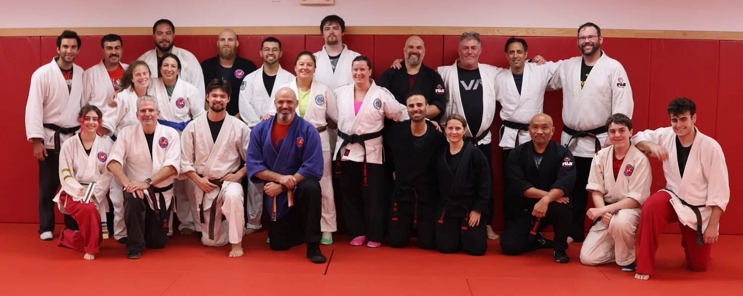 Adult American Jiu-Jitsu students together on the Academy mat