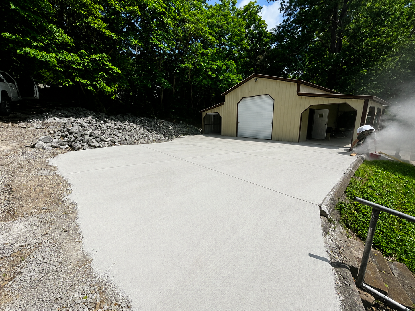 We removed the existing asphalt drive and poured a new concrete drive and pad. Also installed a french drain and rerouted the water away from the house. 