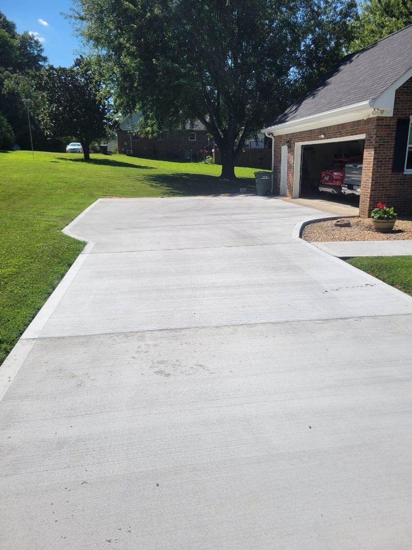 Removed existing cracked driveway and poured this beautiful new drive.