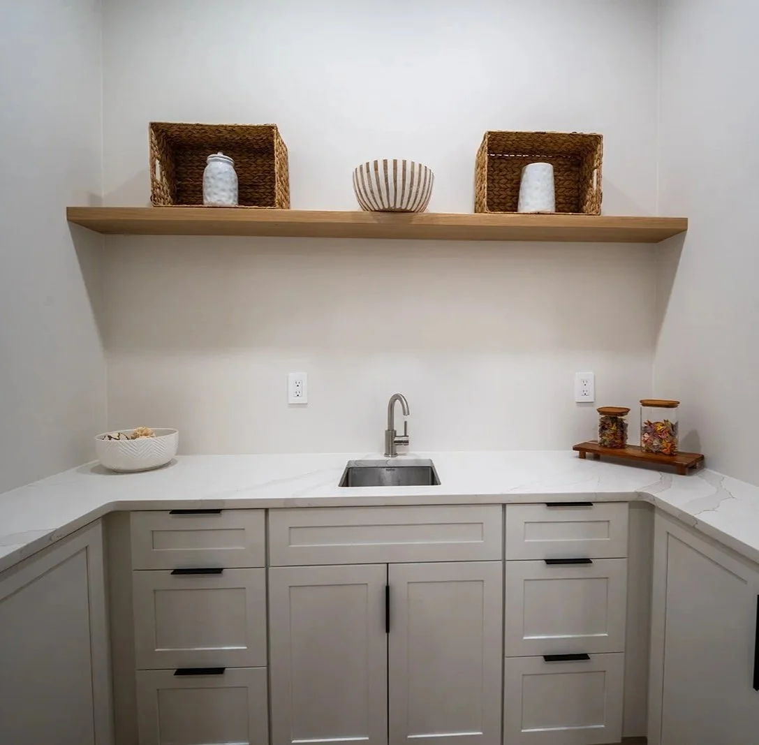 utler’s pantry with quartz countertops, custom cabinetry, floating wood shelving and additional prep and storage space.