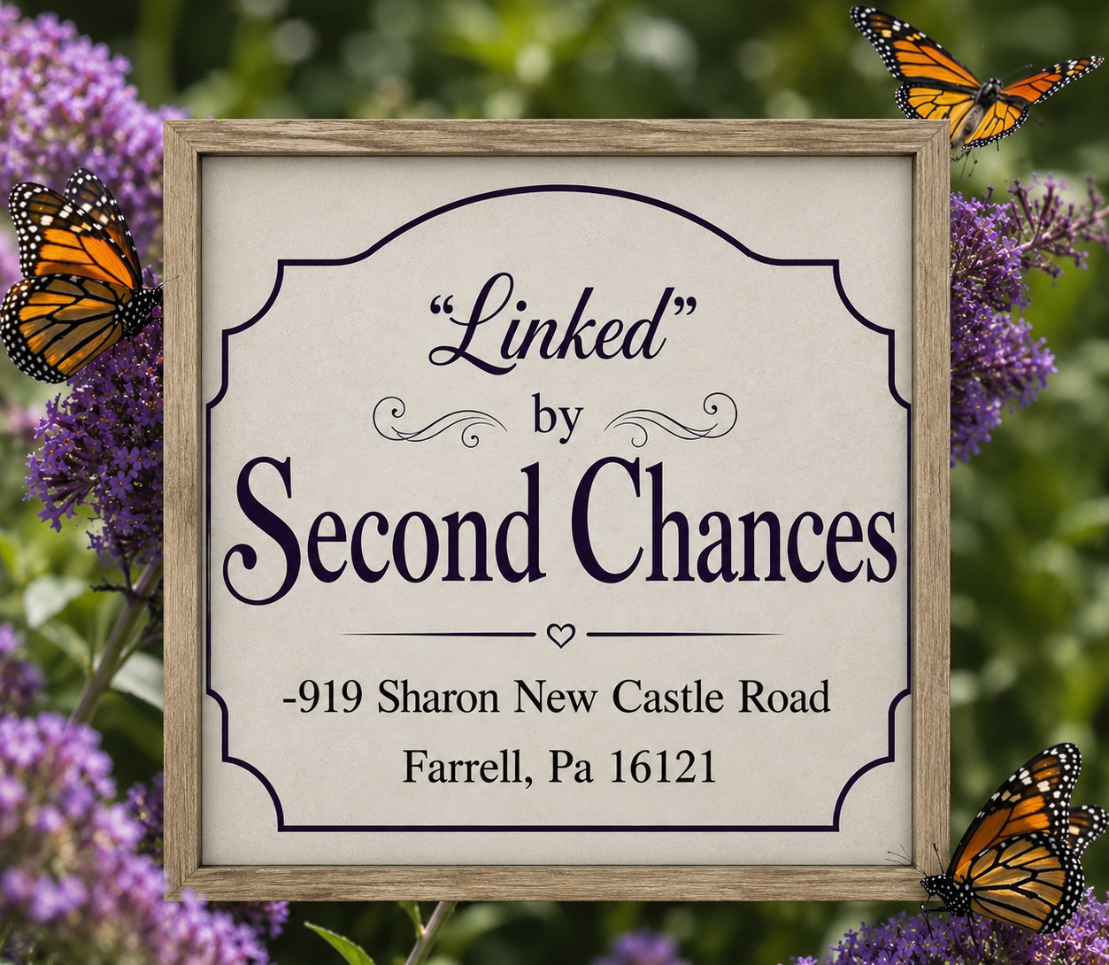 A framed sign with the text "Linked by Second Chances" and address, surrounded by purple flowers and Monarch butterflies.