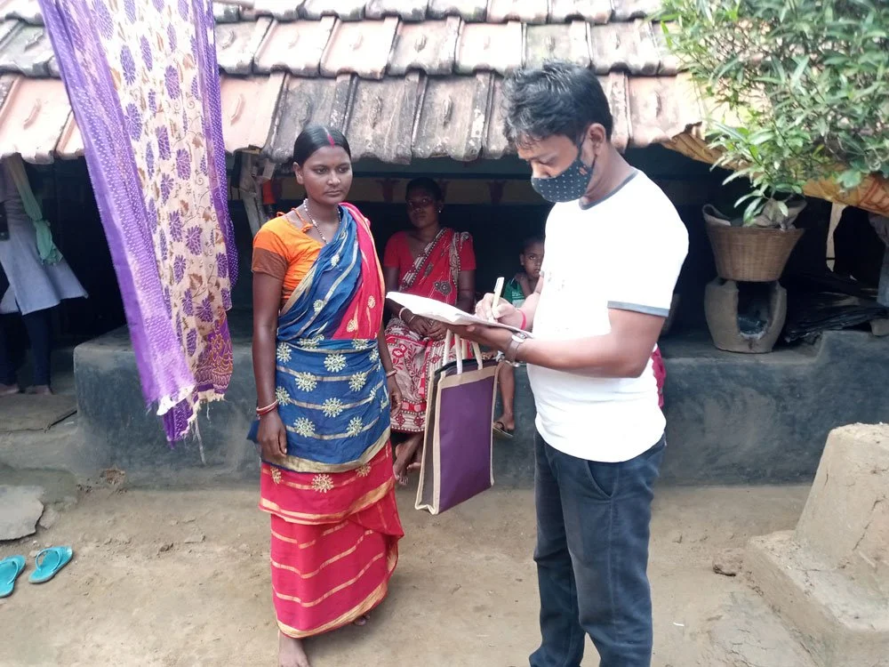 Investigator interviewing tribal women on maternal and neonatal health at Benagoria village of Manbazar I block.