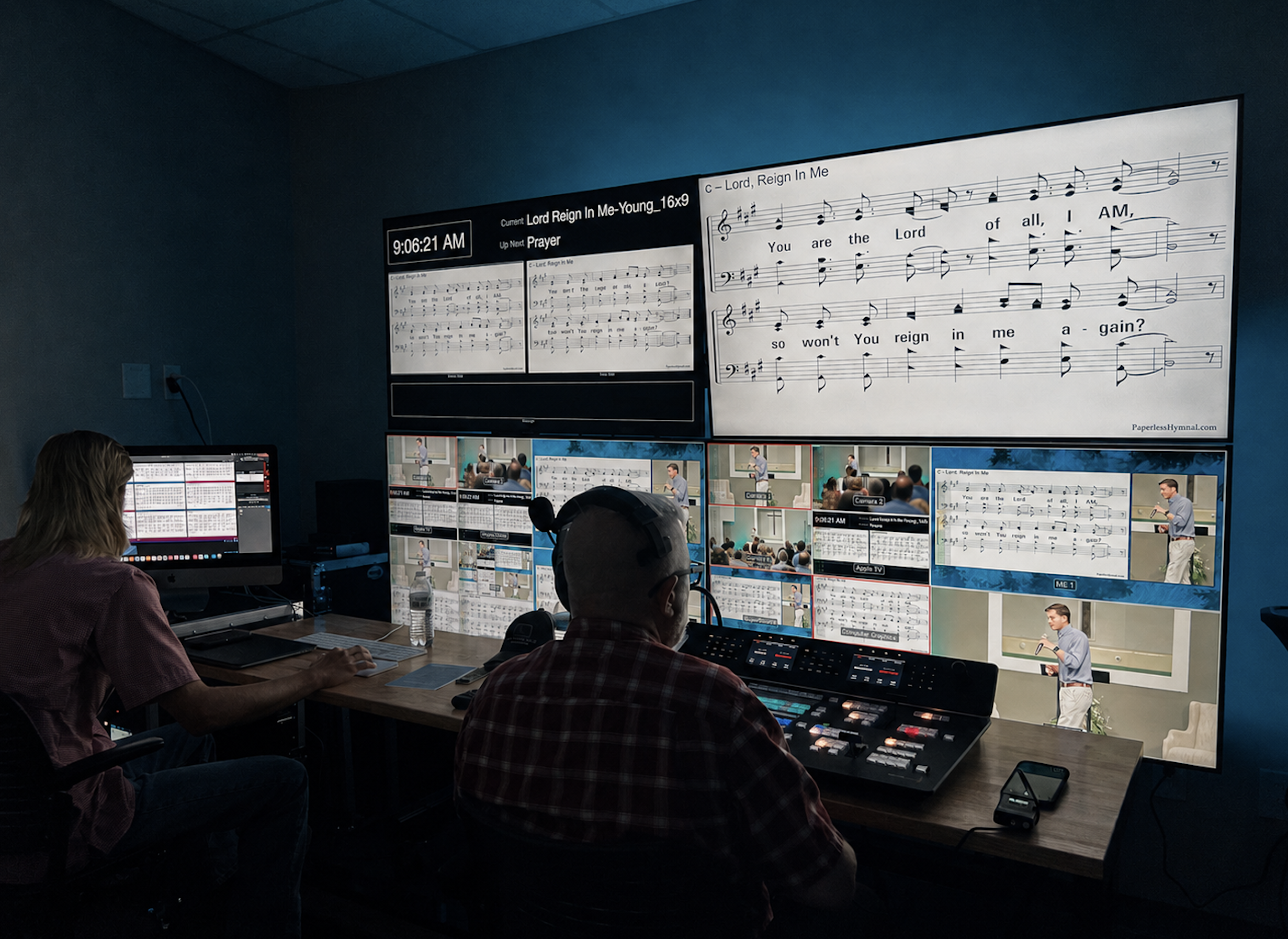 A video production or broadcasting control room with multiple monitors displaying a musical notation. Several people are seated at a desk with audio and video equipment, overseeing a broadcast or recording session.