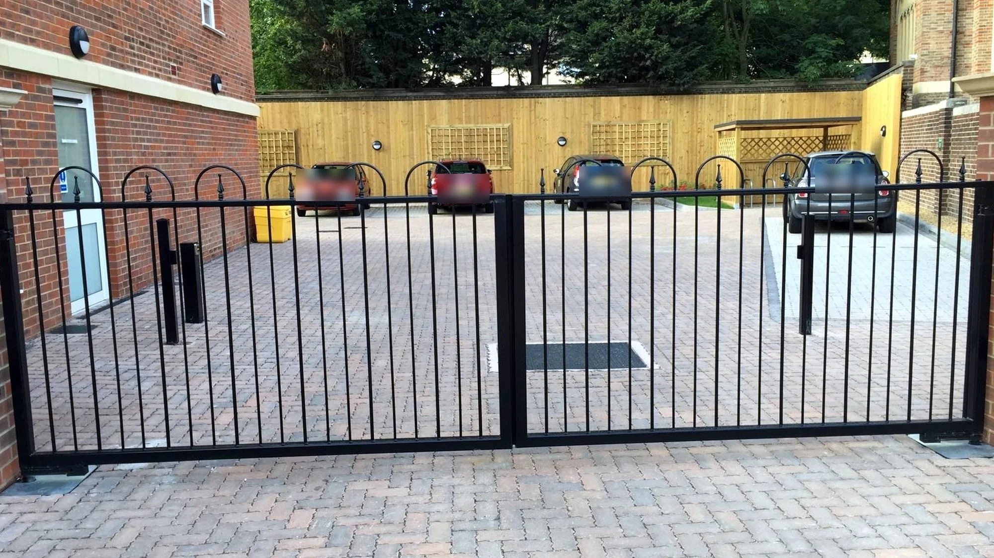 Double swing gates at a residential car park entrance