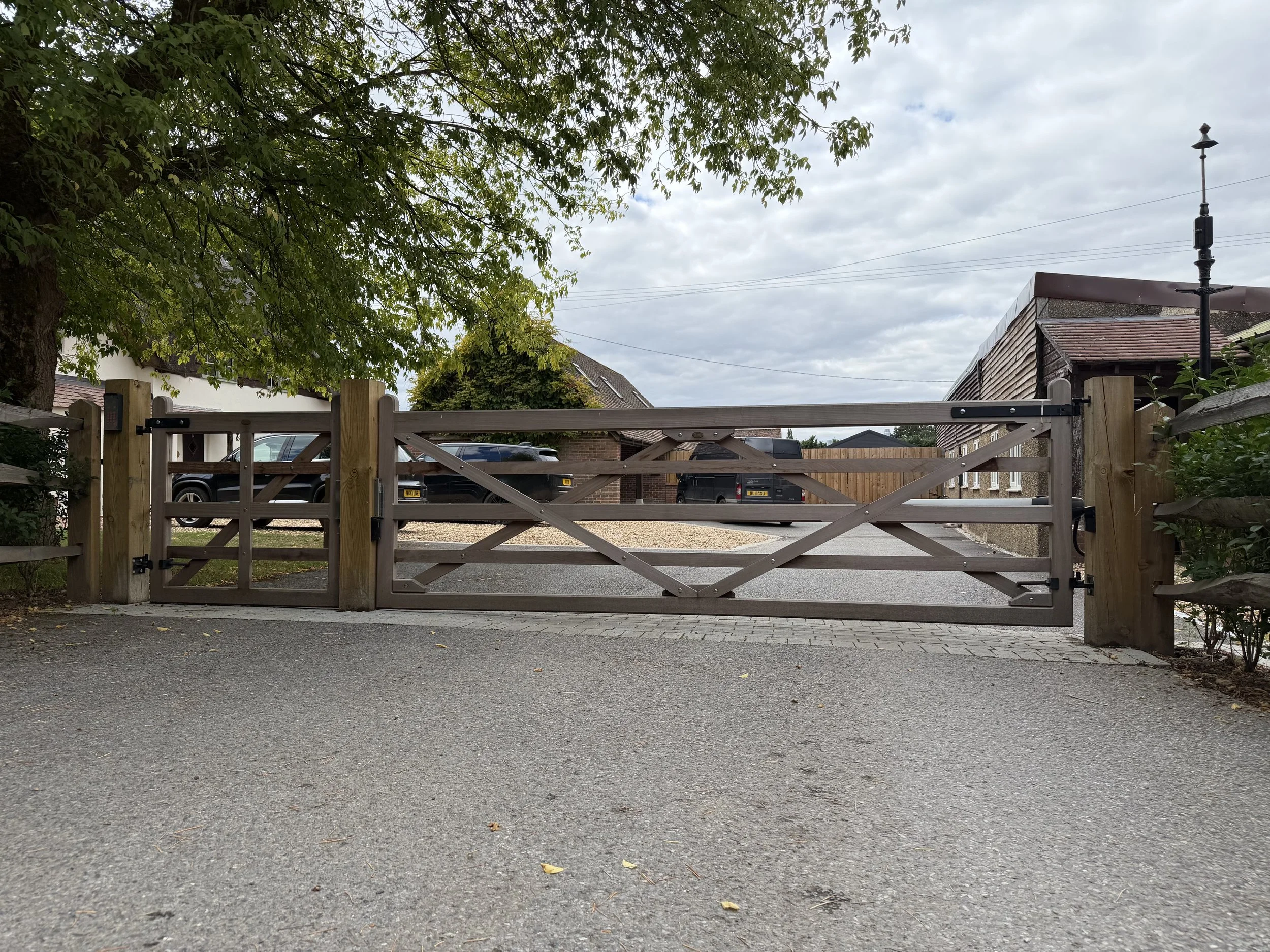 Pair of timber entrance gates across a driveway