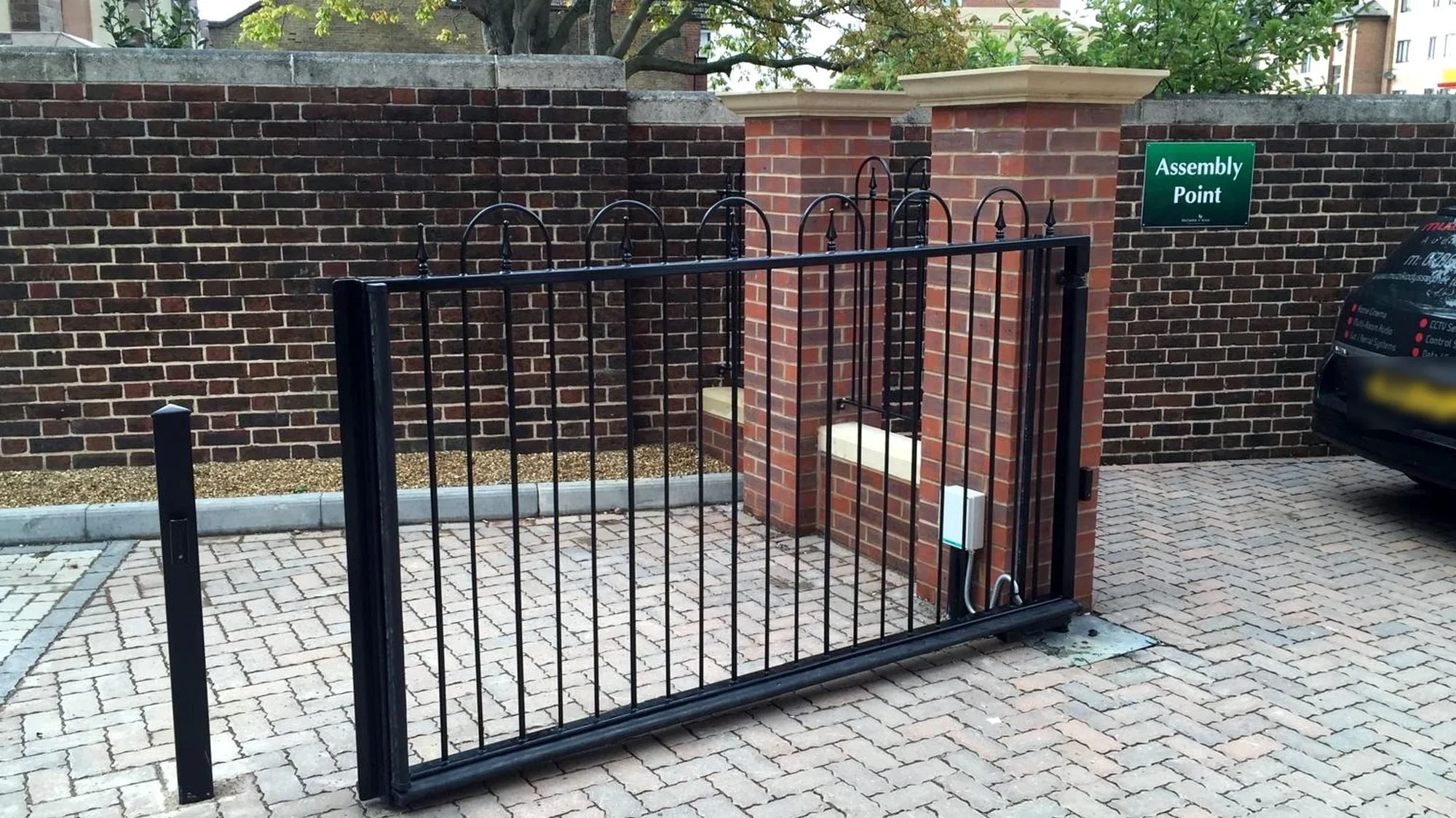 Single swing gate on a block-paved driveway