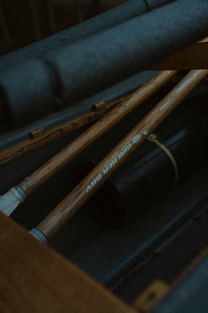 Close-up of two wooden oars resting inside a boat