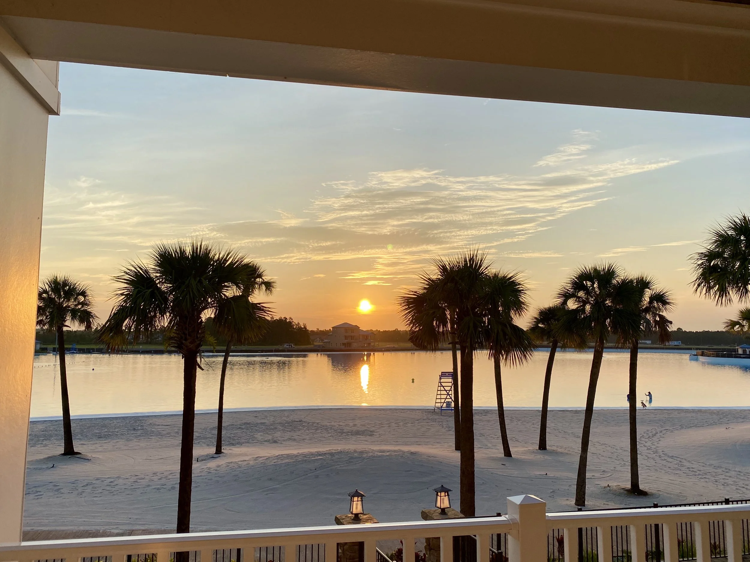 Sunrise over Beachwalk Crystal Lagoon from the second-floor lanai at 155 Rum Runner Way