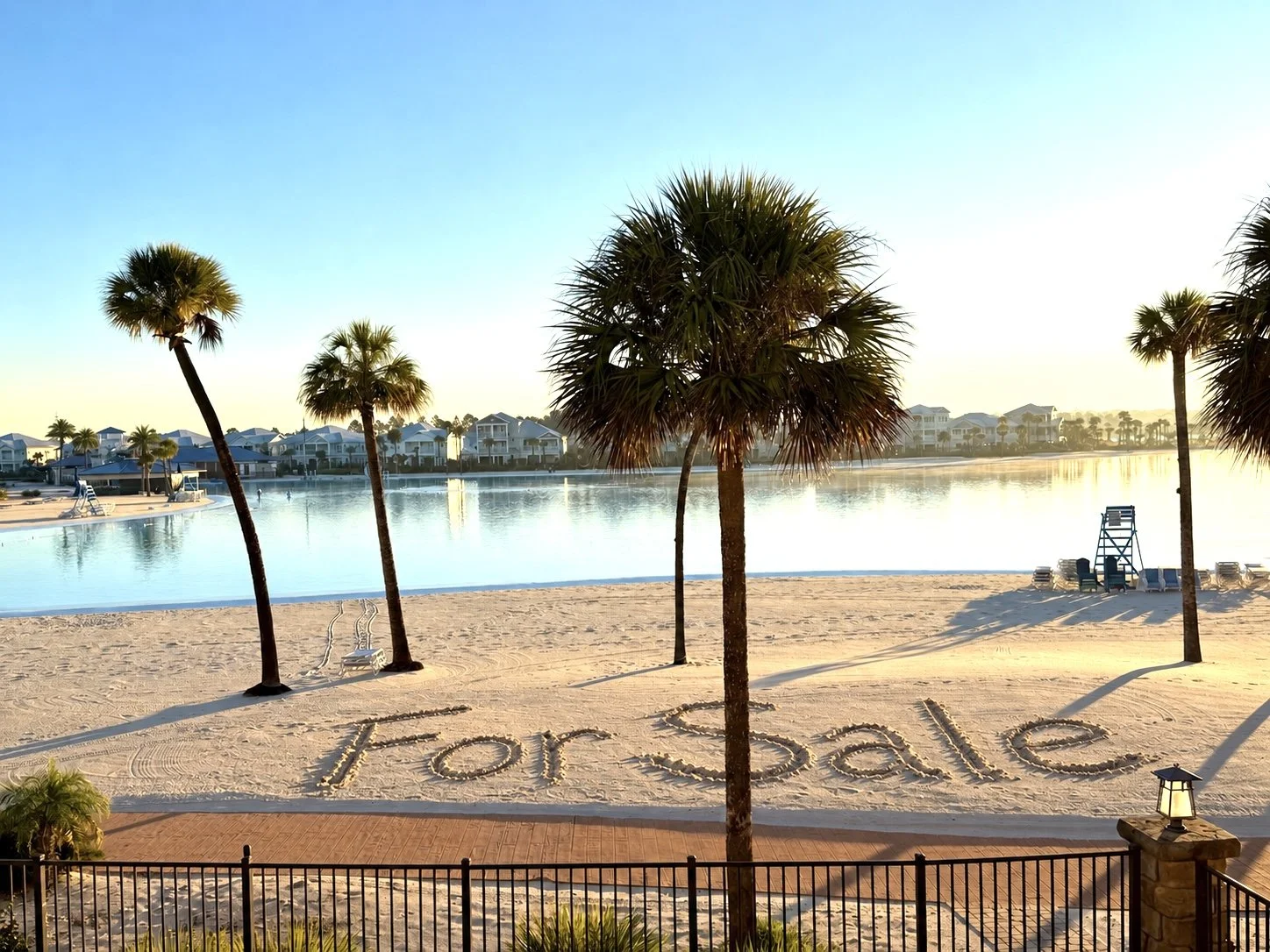 “For Sale” written in the sand beside Beachwalk Crystal Lagoon at 155 Rum Runner Way