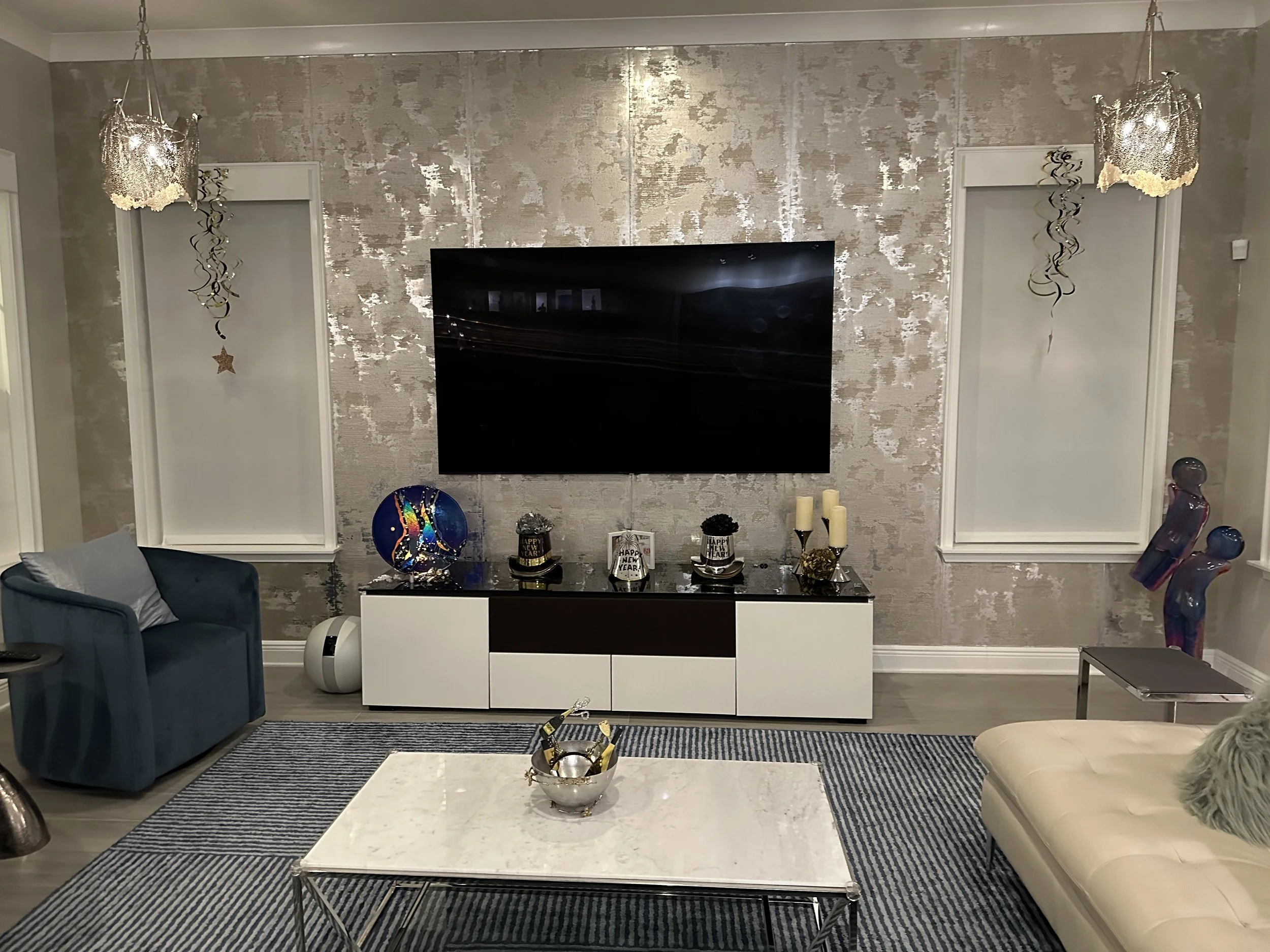 Custom great room media wall with television and decorative display surfaces
