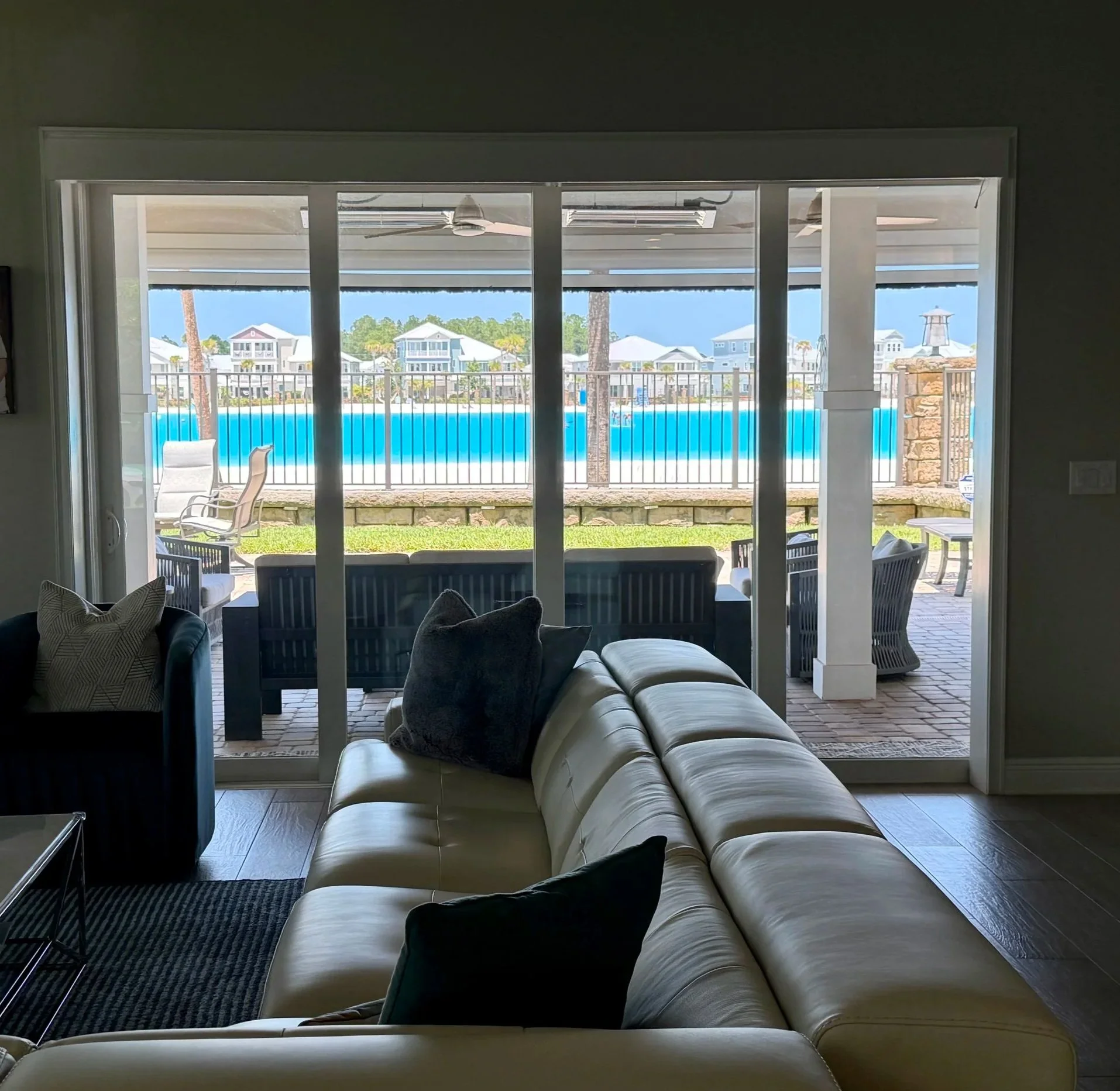 Living room view through the lanai to Beachwalk Crystal Lagoon at 155 Rum Runner Way