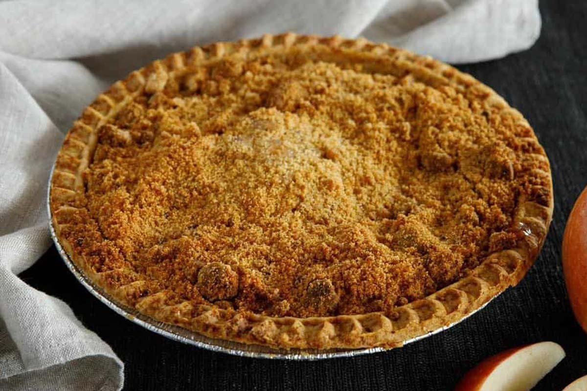 Golden-brown apple crumb pie in a crimped pastry crust