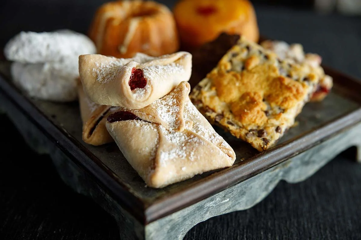 Assorted powdered pastries arranged on a serving tray