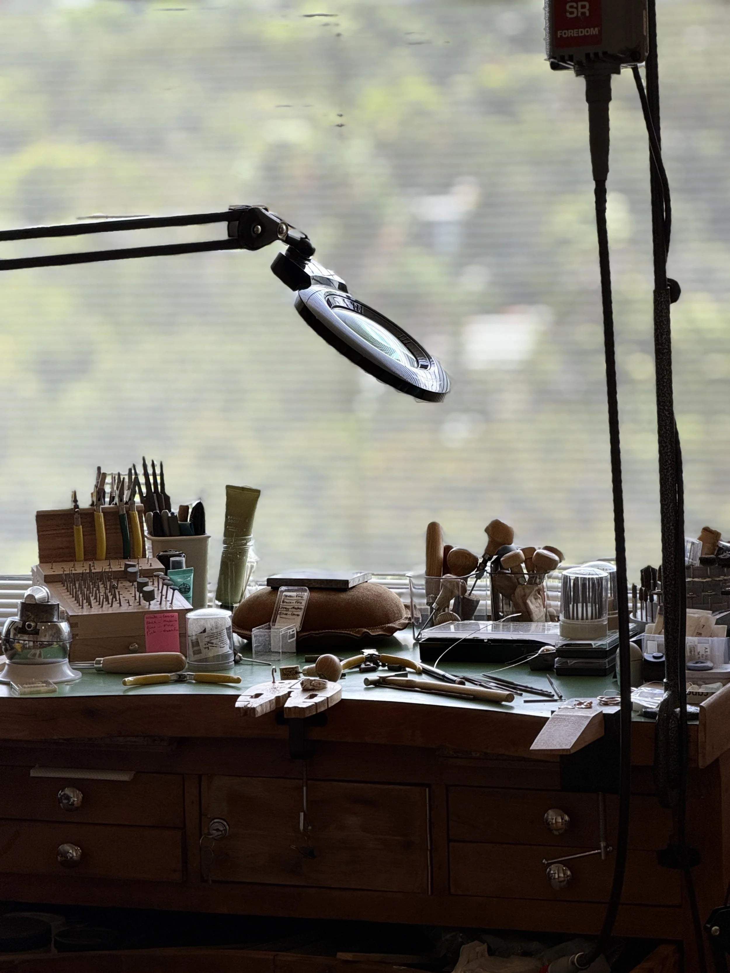 Jeweller’s workbench with jewellery-making tools and equipment in the Avila Jewellery Designs studio.