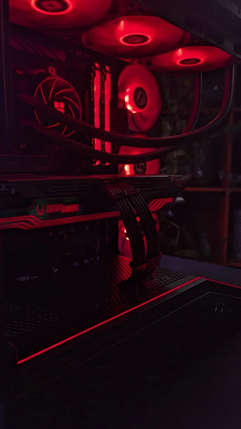 Red-lit custom gaming PC interior with liquid cooling and clean cable routing