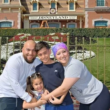 A family together at Disneyland, a mother in treatment with her husband and children