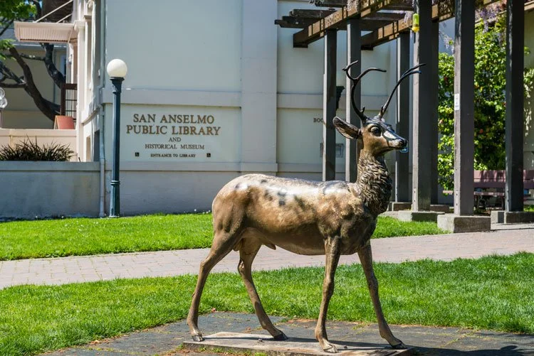 Statue of a deer with antlers in front of San Anselmo Public Library and Historical Museum.