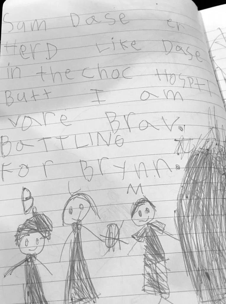 Child's handwritten note with stick figure drawings
