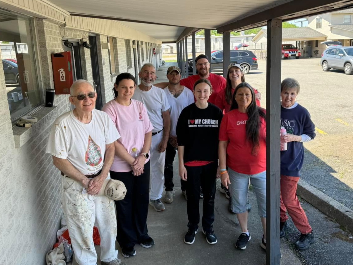 group of volunteers stand together after working