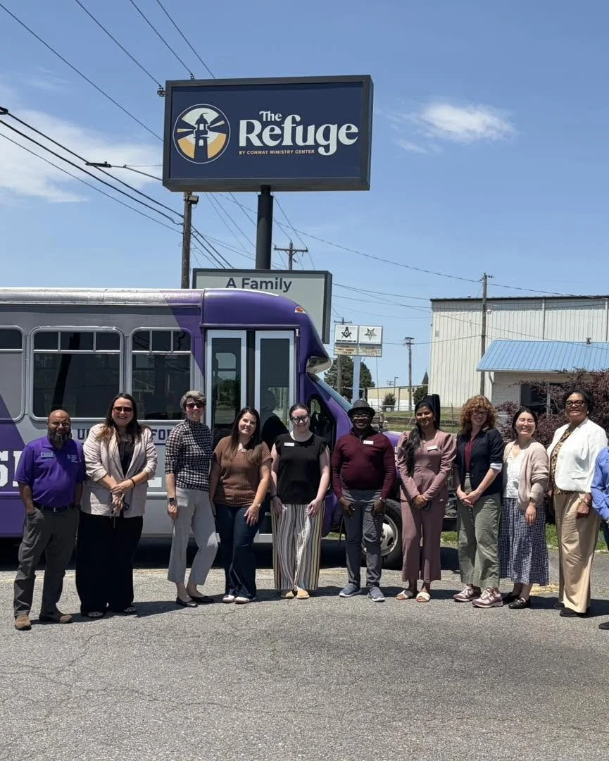 refuge-sign-bus-group-photo.jpg