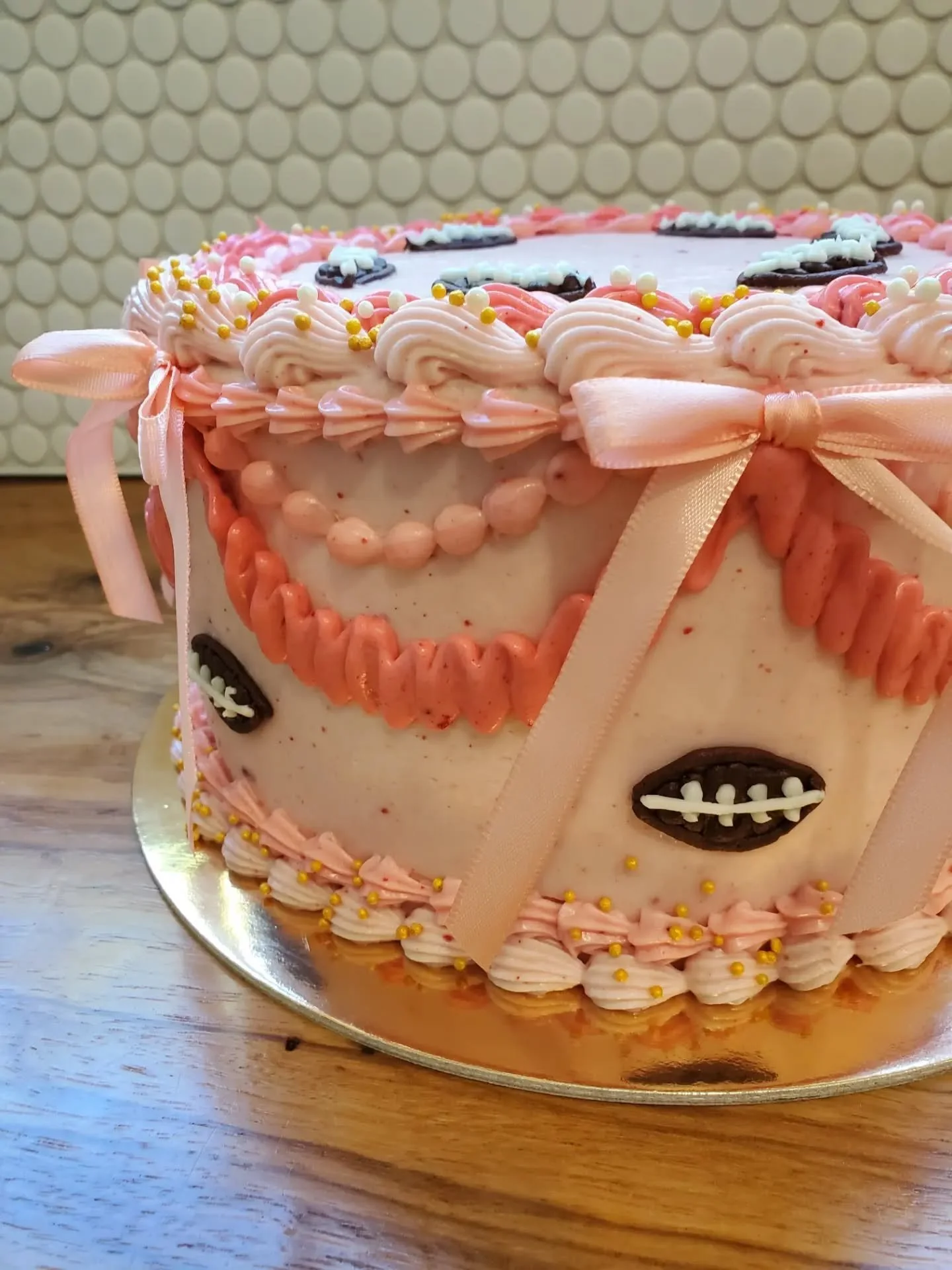 October birthday girls get bows &amp; footballs 🎉

GF confetti cake with strawberry cream cheese frosting 🍓

#drippingspringseats
#drippingspringsbaker
#cakesofinstagram