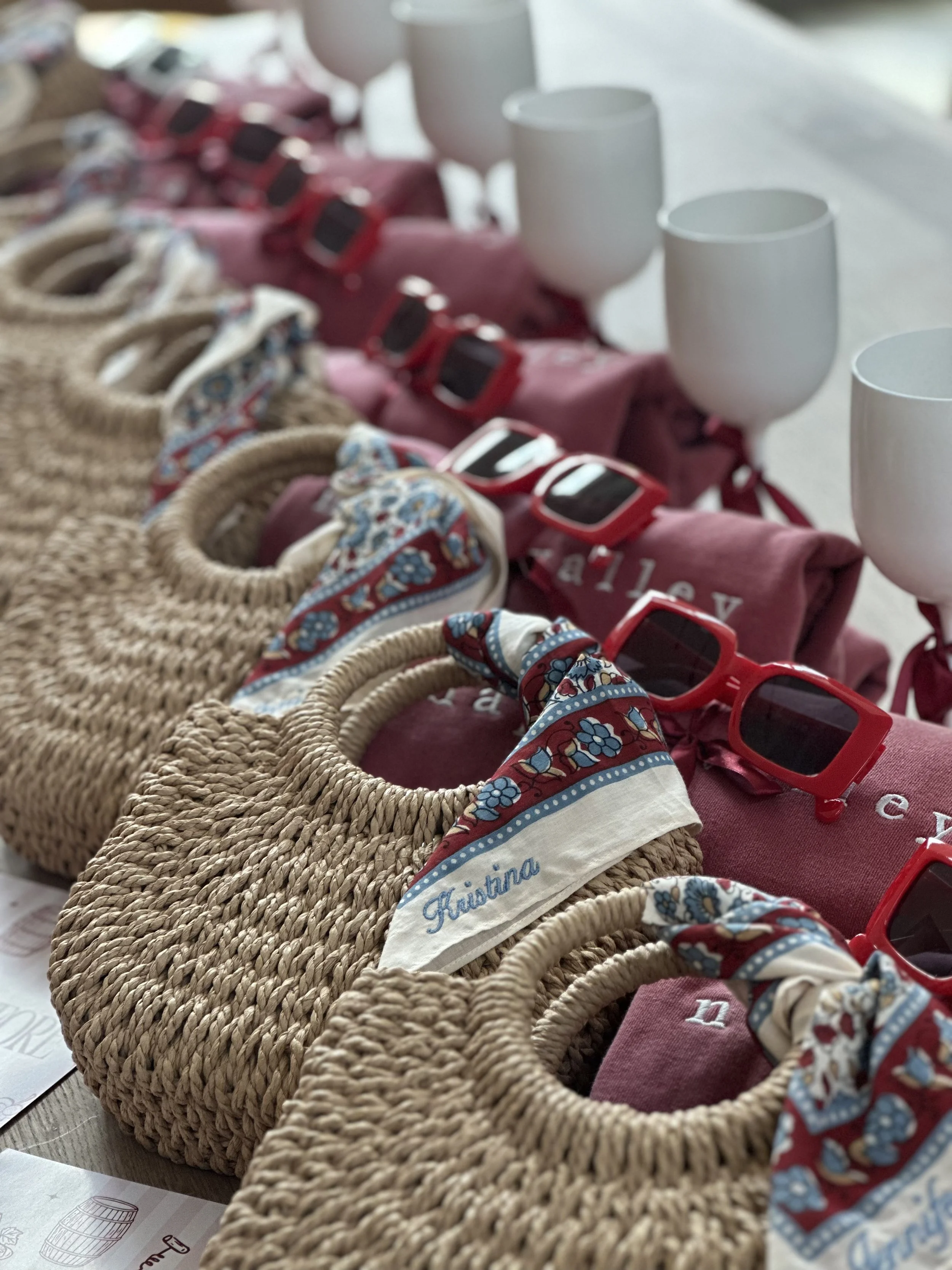 Woven welcome-gift baskets filled with colorful accessories for event guests.