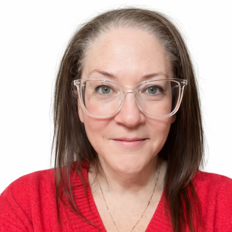 A woman with glasses and long brown hair wearing a red sweater, smiling at the camera.