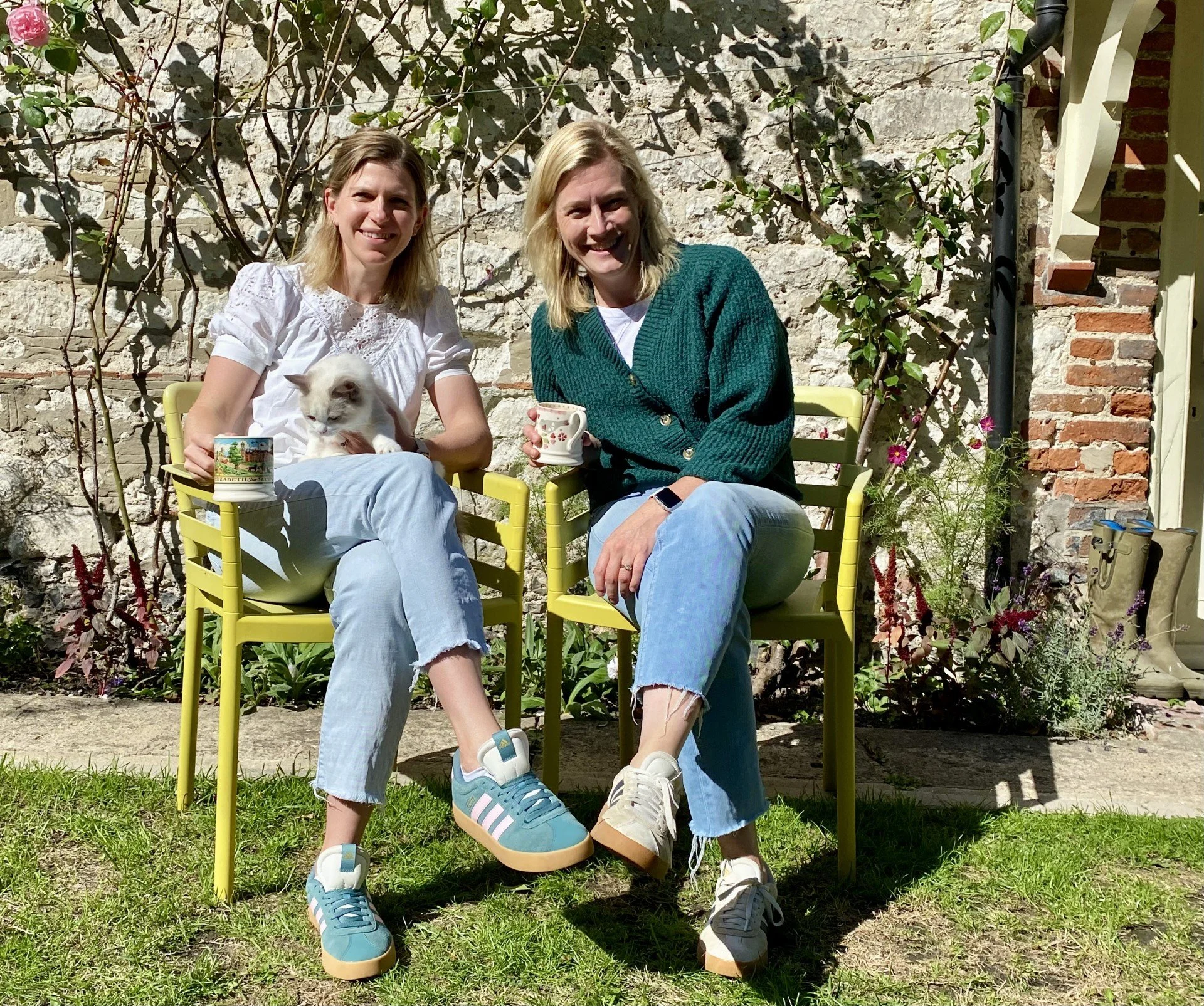 Hilary and Lizzie, founders of Ottie & George Vets, chatting together over coffee
