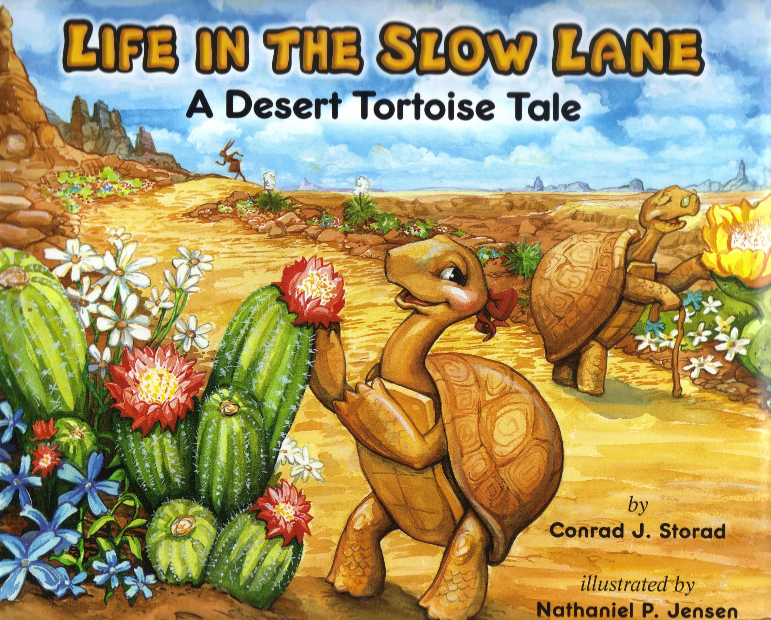 Colorful illustration of a desert landscape with cacti, flowers, and mountains in the background, featuring cartoon-style tortoises with happy expressions. The title reads 'Life in the Slow Lane: A Desert Tortoise Tale' by Conrad J. Storad, illustrated by Nataiel P. Jeosen.
