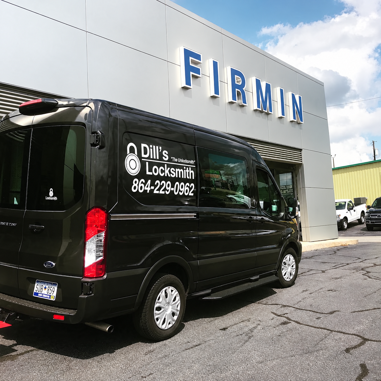 Black locksmith van that says "Dill's Locksmith" parked in front of a large store.