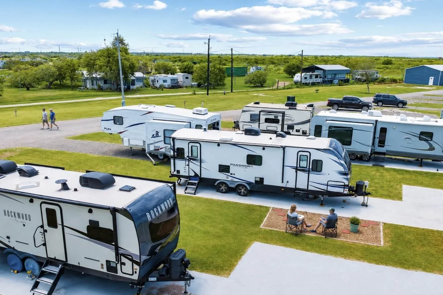 RVs parked at The Hideaway RV Retreat in Rockport, Texas, with guests enjoying the spacious grounds.