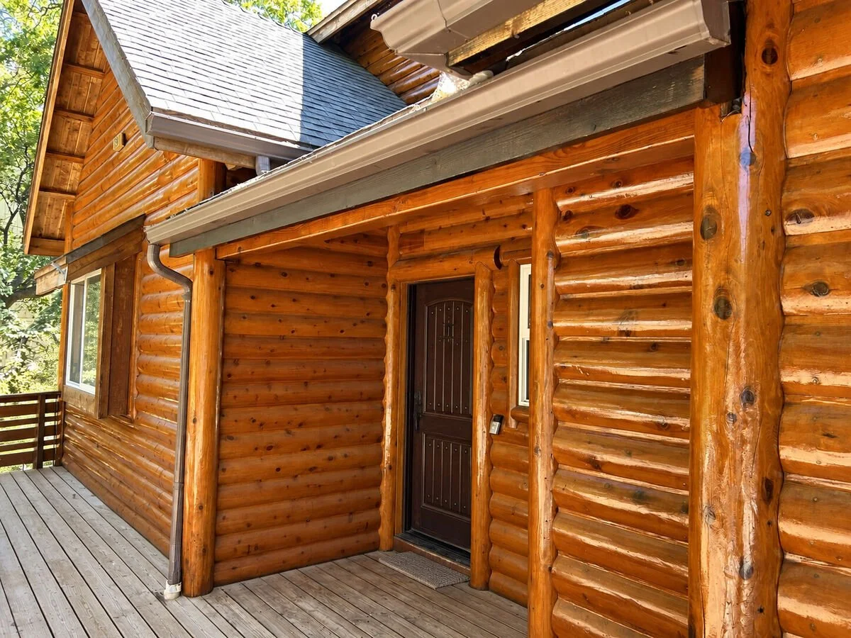 Restored log cabin exterior by Cody Gomez Construction