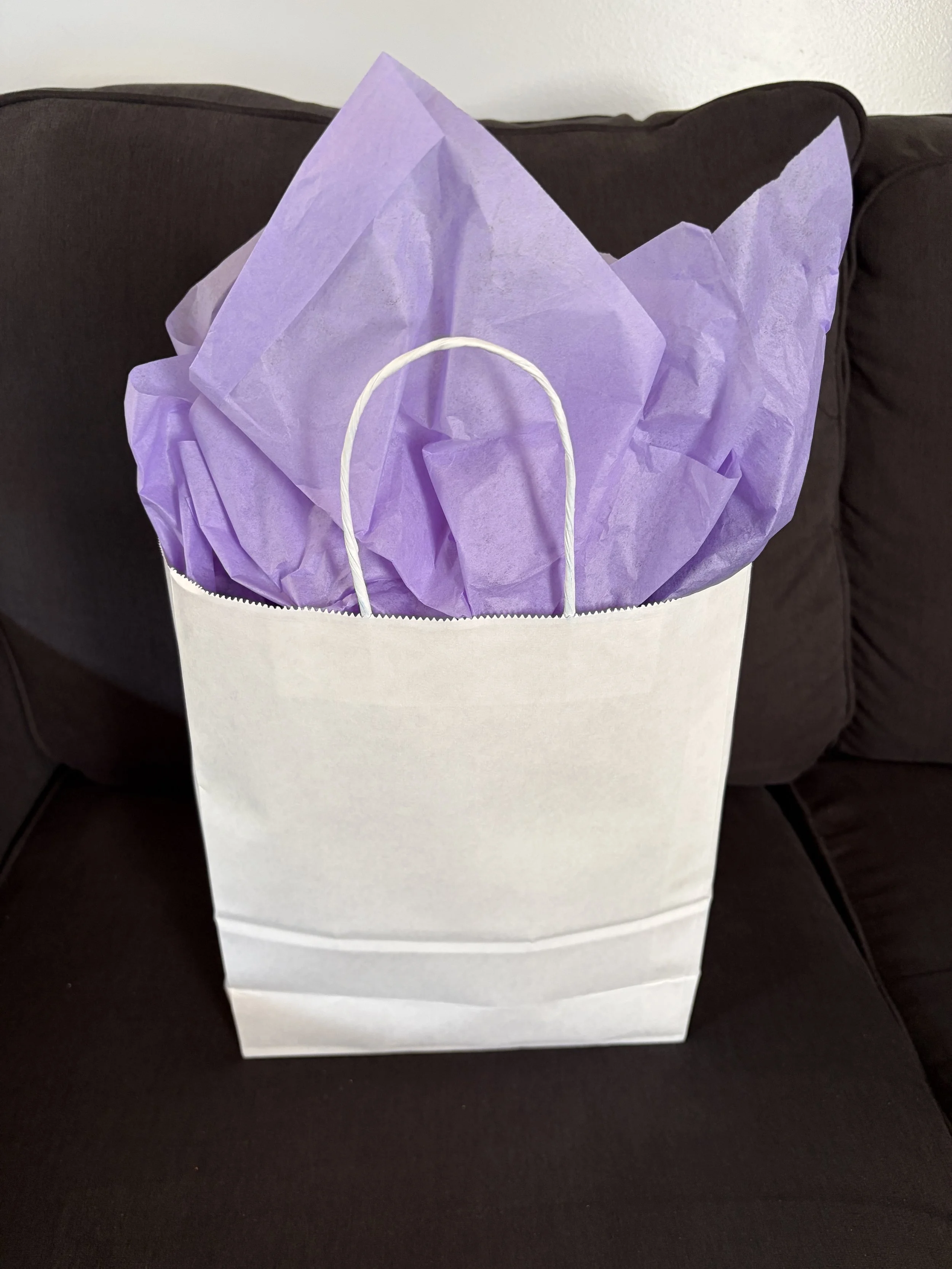 White bag with purple tissue, the student's favorite color