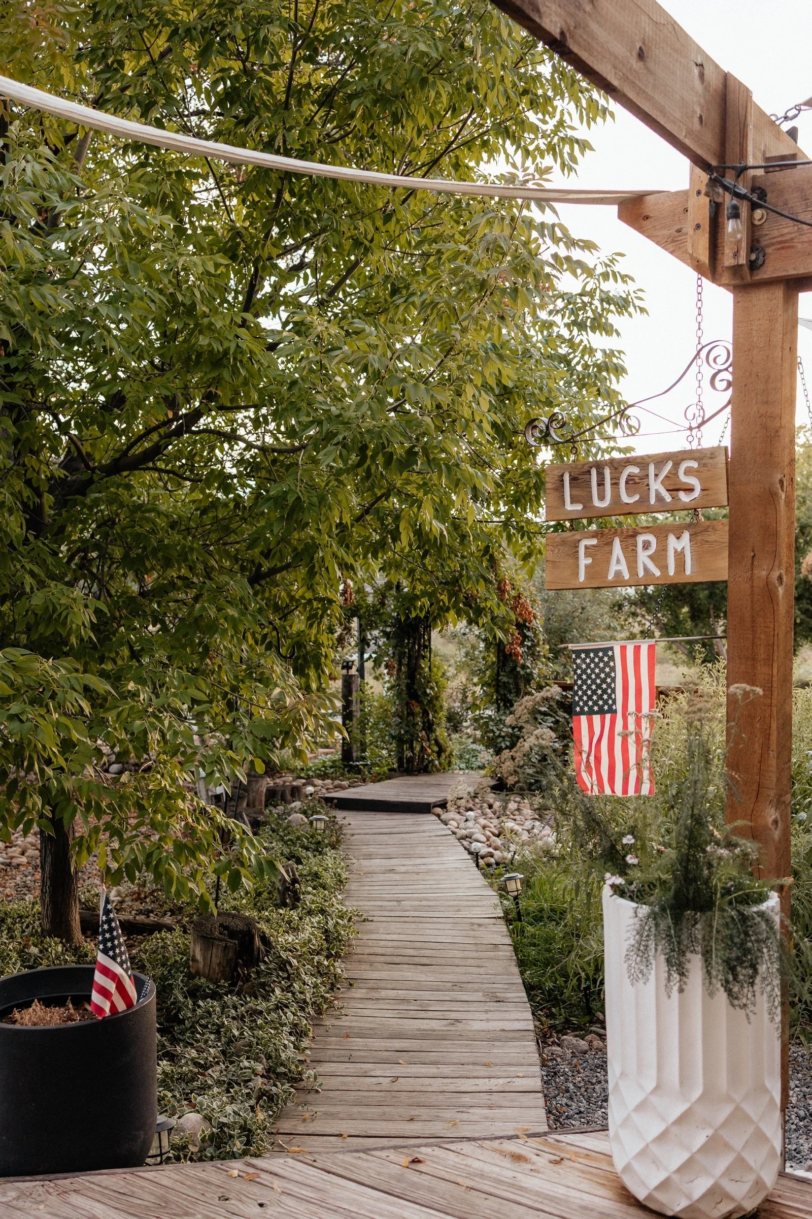 The Lucks Farm wooden sign beside the garden boardwalk