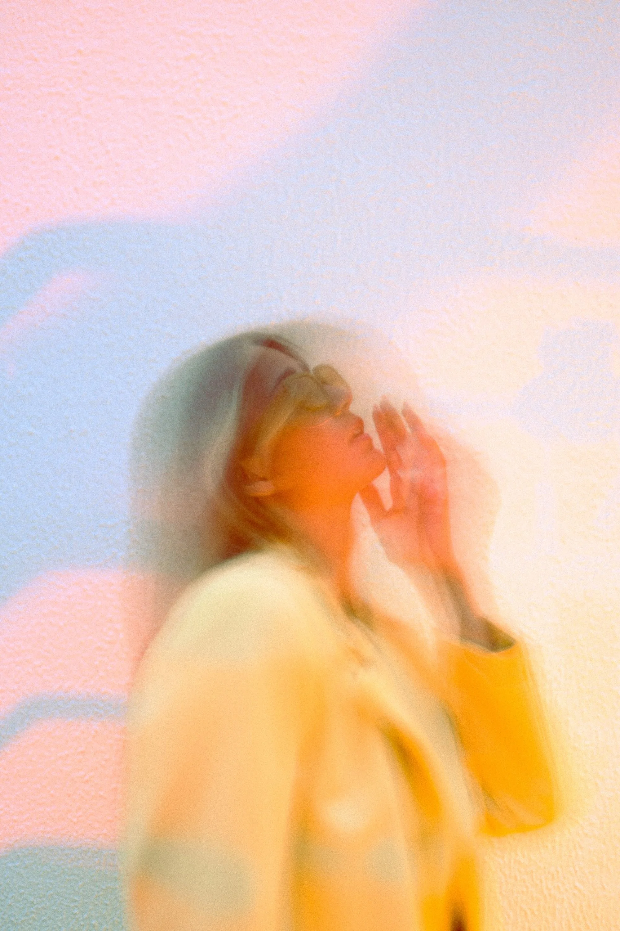 Colorful portrait of a blonde female wearing a yellow jacket and sunglasses