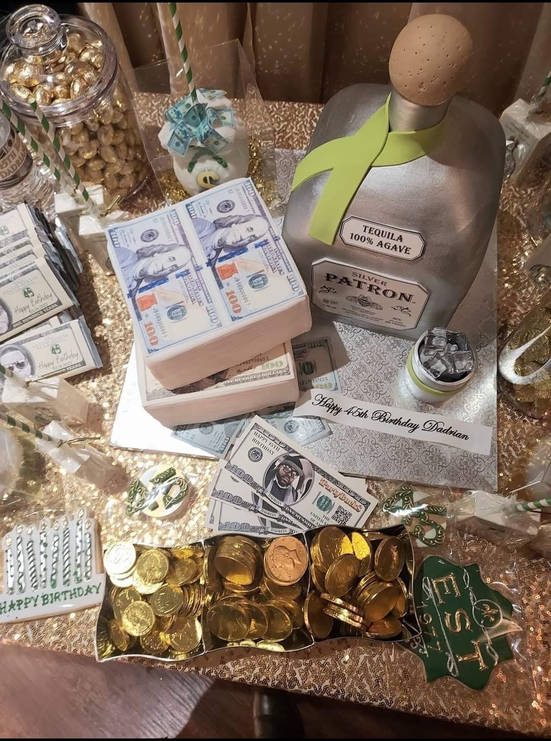 Get Rich or Die Tryin' birthday display with a Patron bottle, play money, gold-wrapped candies, chocolates, striped straws, and a birthday card.