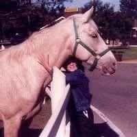 Me as a child hugging a random horse on the side of the road.
