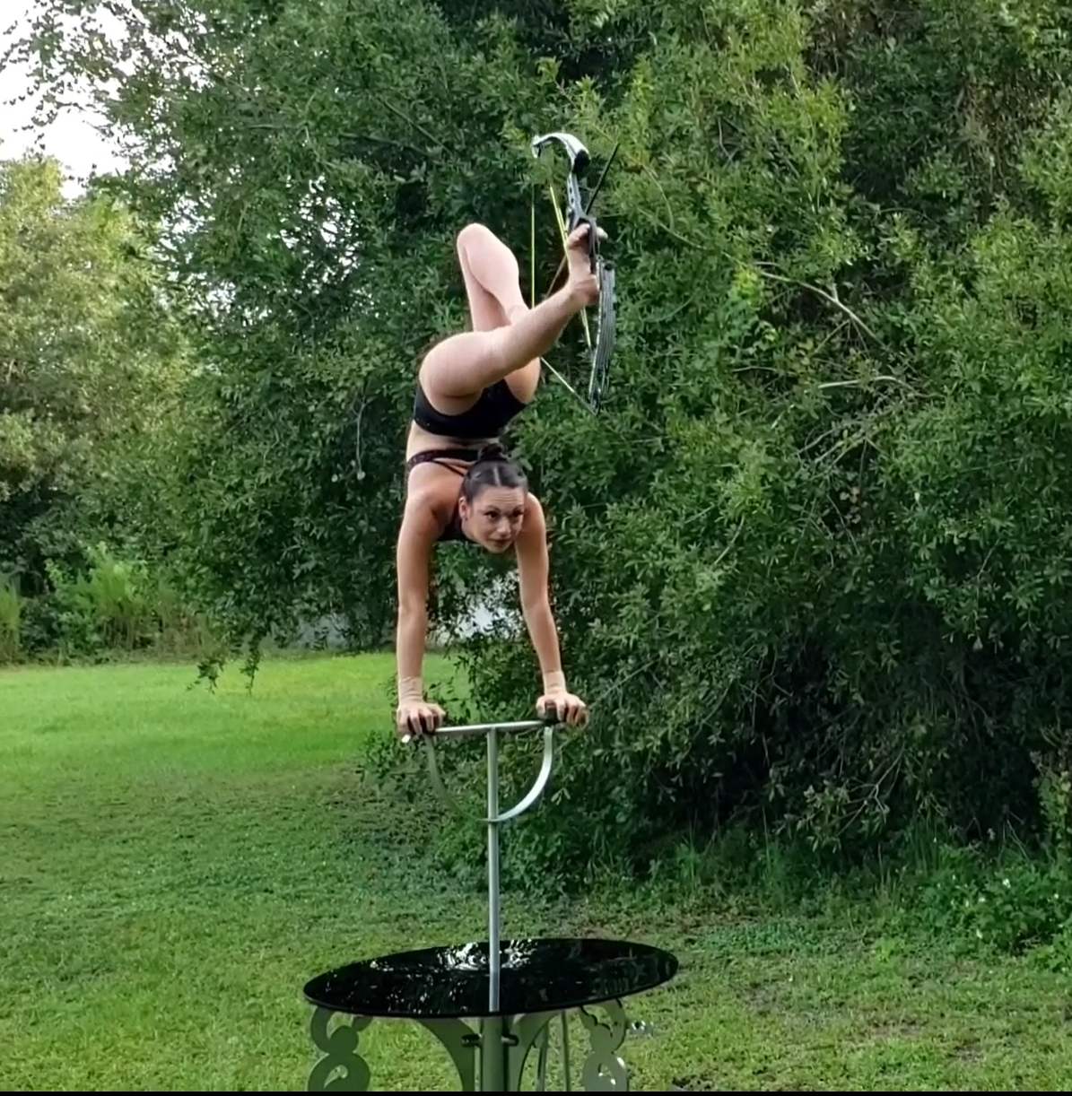“Whoa!“ ”so cool!!!” Elayne Kramer takes aim with a bow and arrow while doing what I can only describe as a backbend and a handstand at the same time